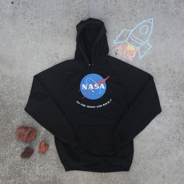 Black NASA pullover hoodie with To the Moon and Back on it with a chalked rocket and red rocks next to it