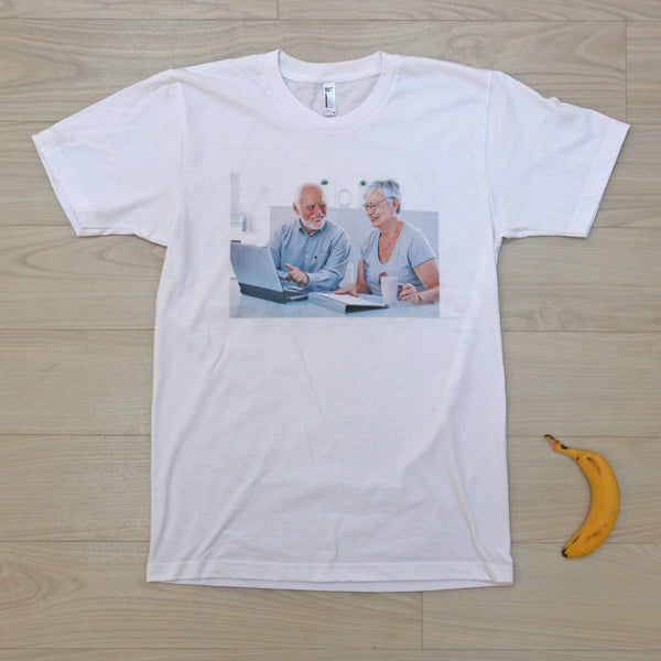 Smiling seniors using a laptop T-shirt with a banana for scale